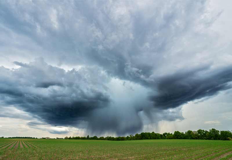 a cloudy sky shows intense weather above a farm